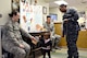 Teziah Davis, 1-year-old, grabs a sticker and crayon from Master Sgt. Tiffany Griego, while her mother, Petty Officer 3rd Class Otisa Williams, with Strategic Communications Wing ONE, and Staff Sgt. Alan Nham, look on. Master Sgt. Griego and Staff Sgt. Nham, both with the 72nd Aerospace Medicine Squadron, handed out goodies and educational materials at the Child Development Center West on April 5 during Public Health Week. (Air Force photo by Kelly White)