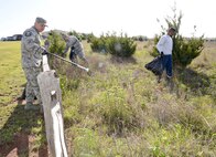 Master Sgt. Nic Husted and Master Sgt. Don Botkins helped pick up trash from the Scissortail Trail area of the Urban Greenway April 28. (Air Force photo by Kelly White)