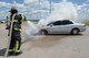 William Green, Tinker Fire and Emergency Services firefighter, sprays water on a vehicle which caught fire May 4, 2017, Tinker Air Force Base, Oklahoma. The privately owned vehicle developed mechanical trouble and caught fire near the Oklahoma City Air Logistics Complexs' building 9001. The fire was quickly and safely extinguished using water and powder while traffic was diverted to an alternate route as workers completed their shifts. Tinker Fire and Emergency Services is a division of the 72nd Civil Engineer Squadron. (U.S. Air Force photo/Greg L. Davis)
