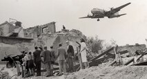 United States Air Force Europe rounded up all of the C-47 Skytrains, affectionately called Gooney Birds, to fly cargo into West Berlin. One of the first to fly over was “Operation Vittles” as West Berliners wait in the rubble for supplies. (Courtesy photo)