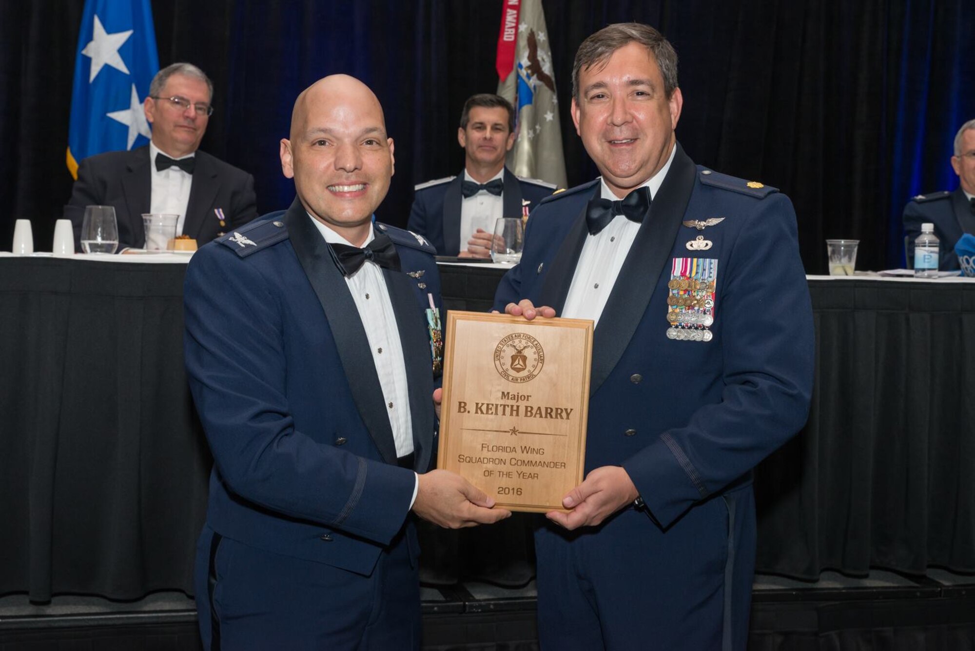 Civil Air Patrol Major Keith Barry, right, the squadron commander with the Civil Air Patrol General Chuck Yeager Cadet Squadron, receives the 2016 Squadron Commander of the Year during the Florida Wing Conference in Orlando, Fla., April 29, 2017. The Civil Air Patrol mission focuses on emergency services, aerospace education, and cadet programs. (courtesy photo)
