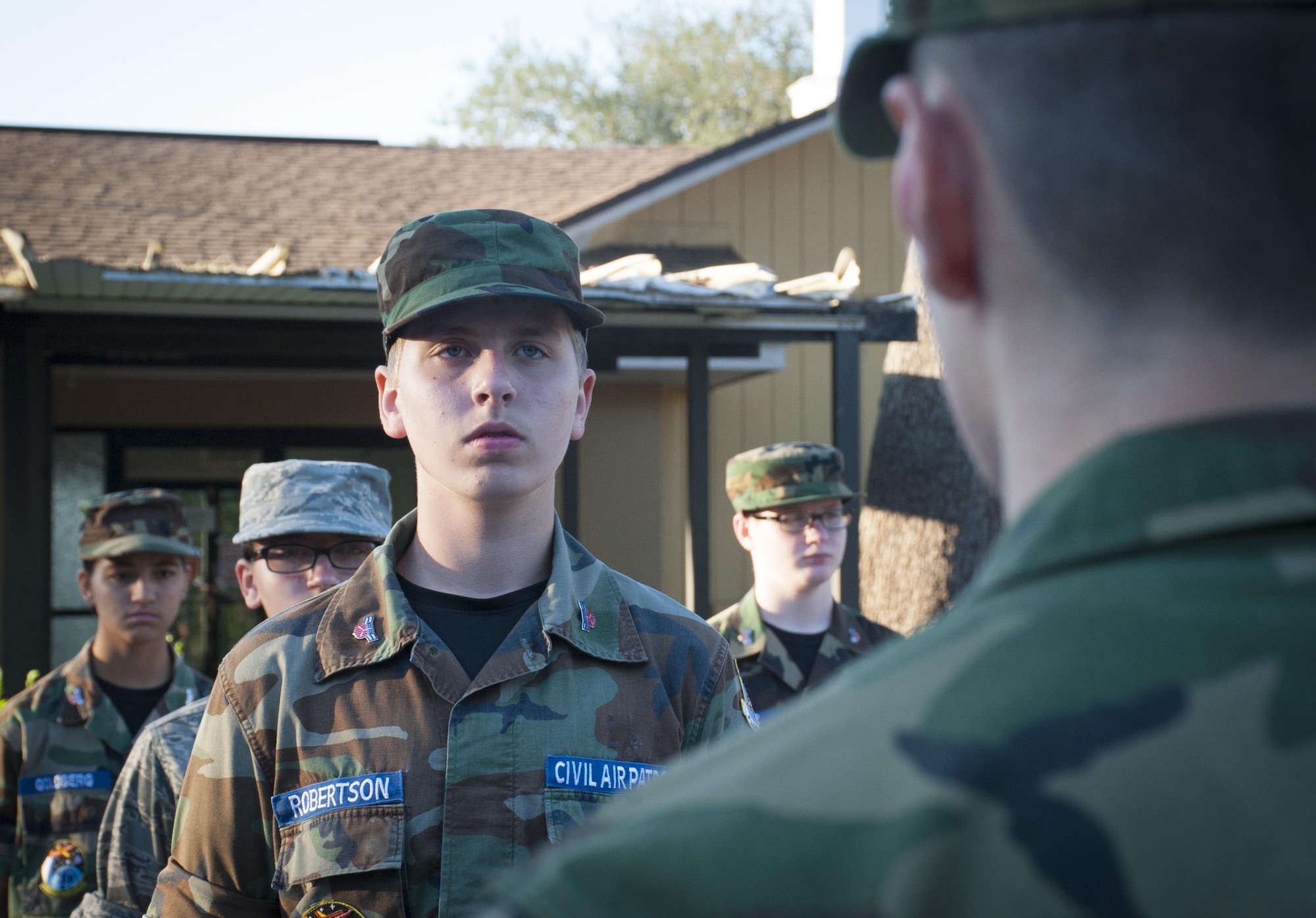 Civil Air Patrol (CAP) General Chuck Yeager Cadet Squadron cadets stand at attention in formation during a practice drill session in Brandon, Fla., May 8, 2017. The squadron received both the Florida CAP Wing 2017 Squadron of Merit award and the 2017 CAP Squadron of Distinction award for the southeast region. (U.S. Air Force by Airman 1st Class Mariette Adams)