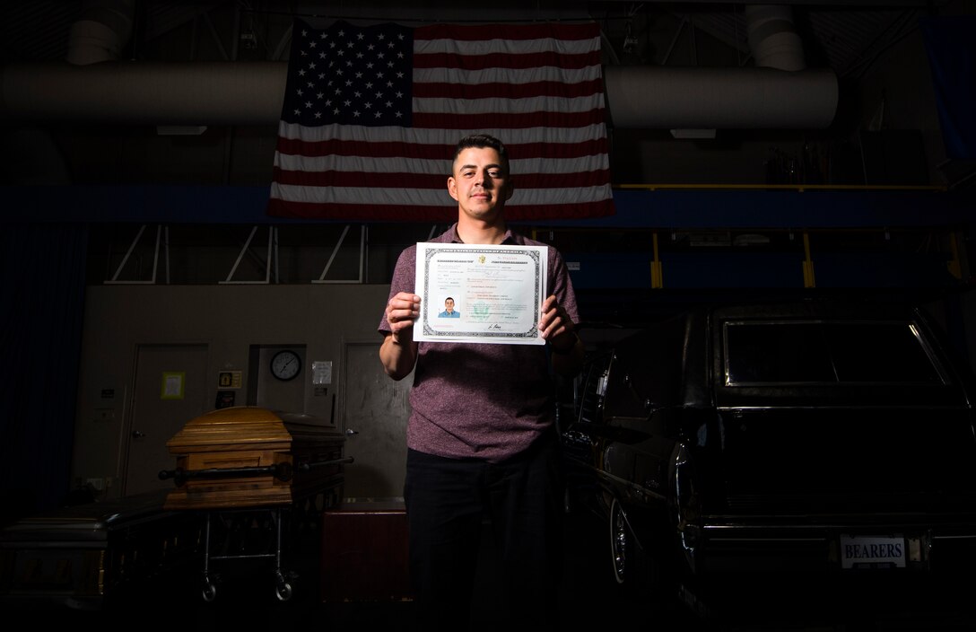 Jose Velazquez, U.S. Air Force Honor Guard firing party member, holds his citizenship paperwork inside Ceremonial Hall at Joint Base Anacostia-Bolling, District of Colombia, April 20, 2017. Velazquez came to America with his parents at a young age and gained citizenship after completing Air Force basic training. (U.S. Air Force photo by Senior Airman Philip Bryant)