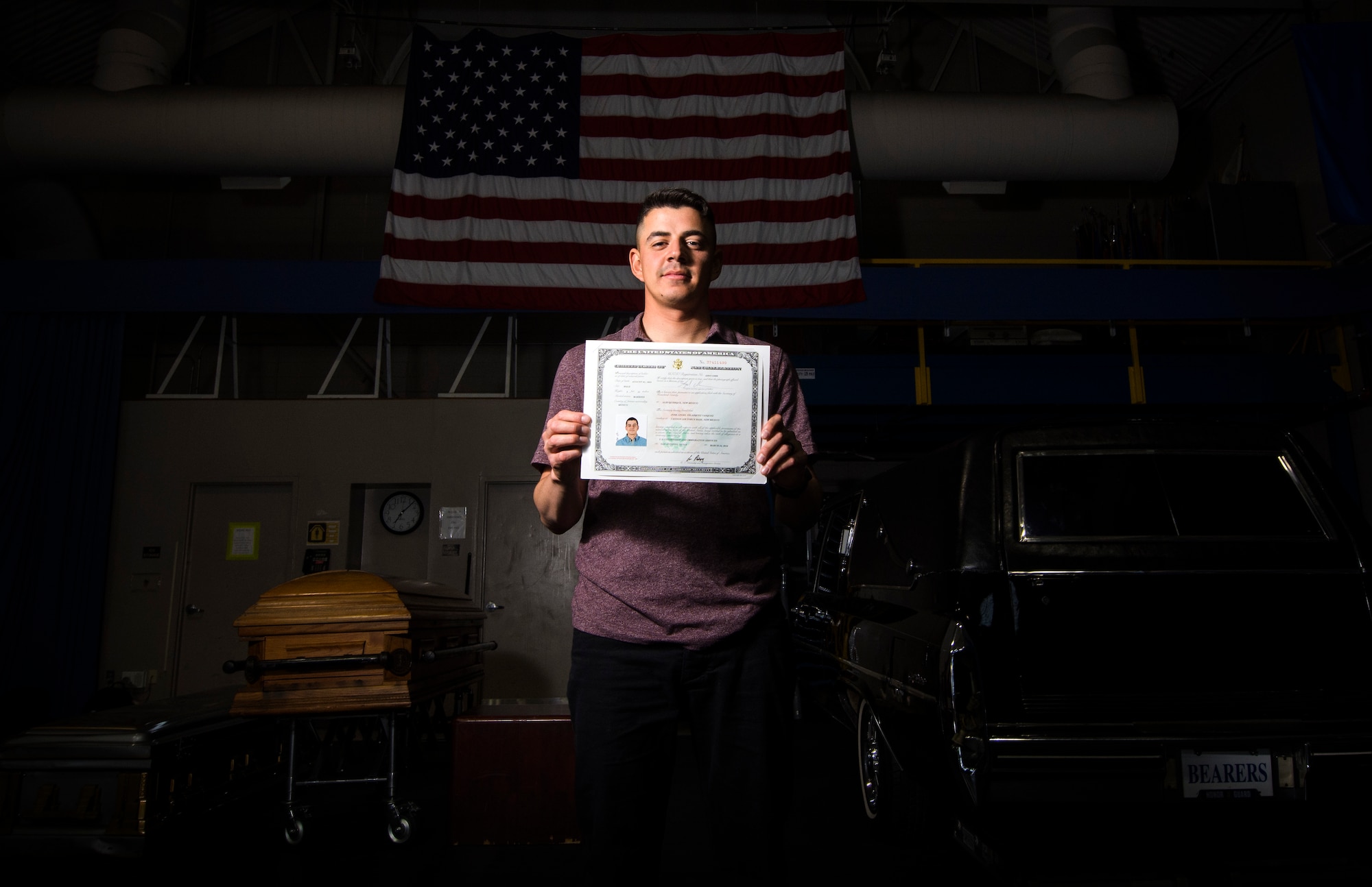 Jose Velazquez, U.S. Air Force Honor Guard firing party member, holds his citizenship paperwork inside Ceremonial Hall at Joint Base Anacostia-Bolling, District of Colombia, April 20, 2017. Velazquez came to America with his parents at a young age and gained citizenship after completing Air Force basic training. (U.S. Air Force photo by Senior Airman Philip Bryant)