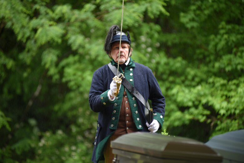 John Henry Bredenfoerder, president of the Cincinnati Chapter Ohio Society of the National Society of the Sons of the American Revolution, pays tribute to American Revolutionary Private Samuel Howard during a reinterment ceremony at Resthaven Cemetery in Baxter, Ky., May 12, 2017. 