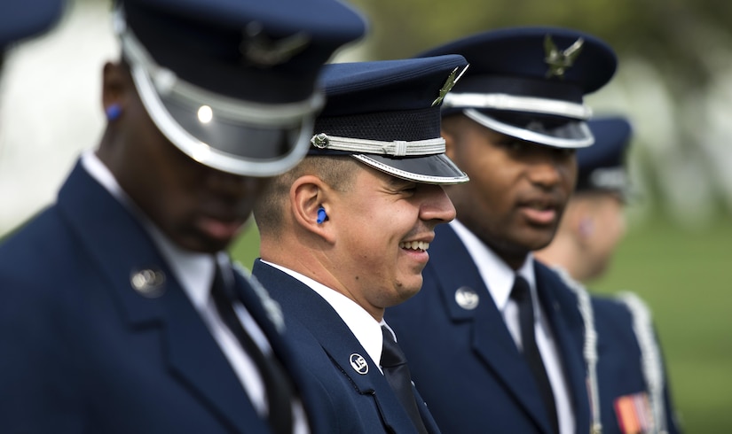 Airman 1st Class Jose Velazquez, U.S. Air Force Honor Guard firing party member, smiles with other firing party members at Arlington National Cemetery in Arlington, Va., April 13, 2017. Velazquez gained citizenship after completing Air Force basic training and is now in a coveted position amongst the U.S. Air Force Honor Guard firing party. (U.S. Air Force photo by Senior Airman Philip Bryant)