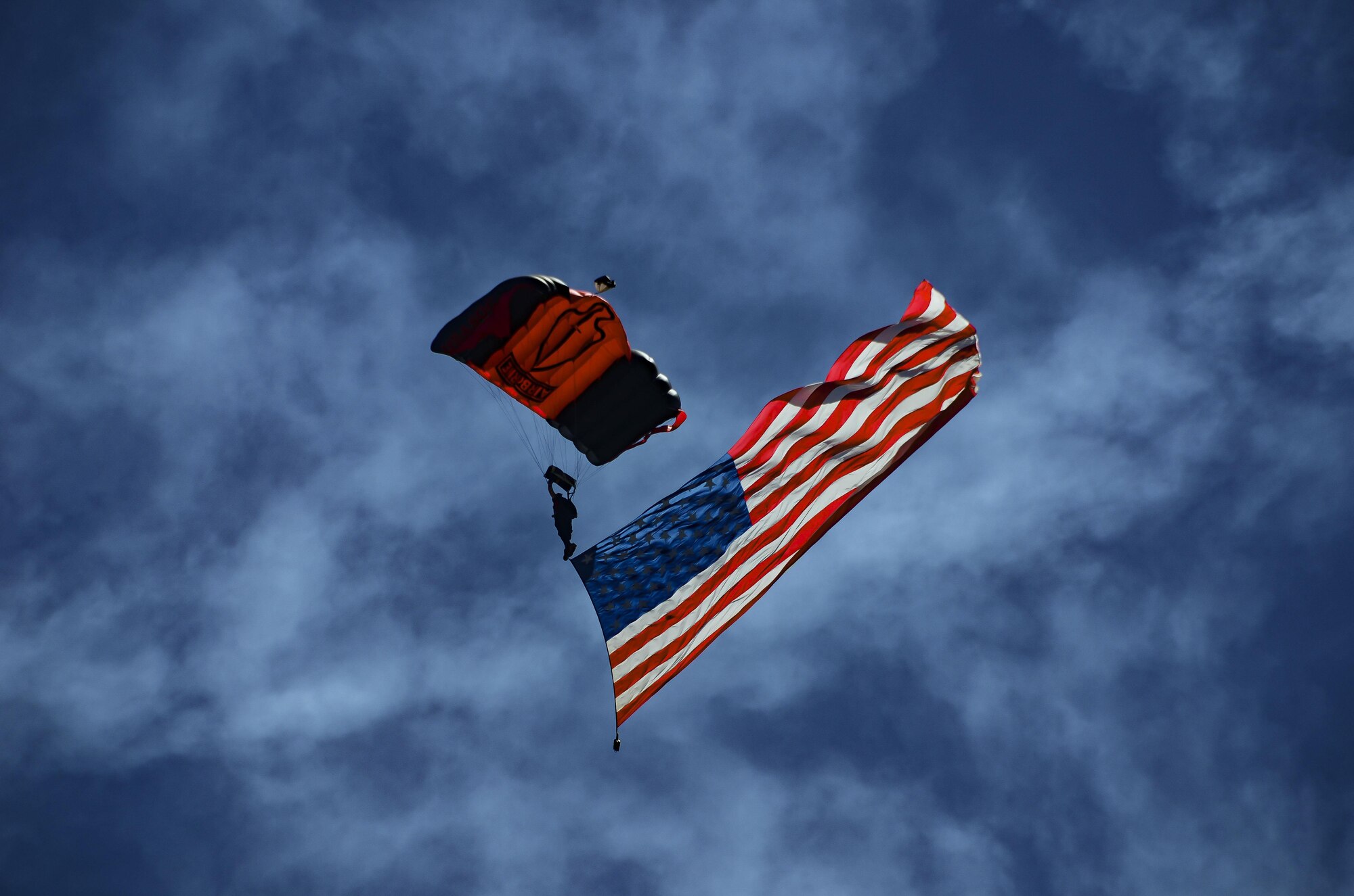 The U.S. Army Special Operations Command Black Daggers Parachute Team jumps with the American Flag during the South Carolina National Guard Air and Ground Expo at McEntire Joint National Guard Base, South Carolina, May 7, 2017. This expo is a combined arms demonstration showcasing the abilities of South Carolina National Guard Airmen and Soldiers while saying thank you for the support of fellow South Carolinians and the surrounding community. (U.S. Air National Guard photo by Tech. Sgt. Nicole Szews)