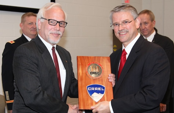 HANOVER, N.H. – Dr. Joseph L. Corriveau (left) takes the reins as he accepts the Cold Regions Research and Engineering Laboratory seal from U.S. Army Engineer Research and Development Center (ERDC) Director Dr. David W. Pittman (right) here May 15 ERDC Commander Col. Bryan S. Green (left rear) and out-going Director Dr. Robert E. Davis (right rear) were also key members of the transition ceremony.