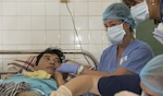 Christine Booth, Project Hope volunteer, comforts a burn victim receiving medical care from U.S. Navy doctors Vietnamese doctors at Da Nang General Hospital during Pacific Partnership 2017 Da Nang May 9. Pacific Partnership is the largest annual multilateral humanitarian assistance and disaster relief preparedness mission conducted in the Indo-Asia-Pacific and aims to enhance regional coordination in areas such as medical readiness and preparedness for manmade and natural disasters. 