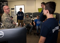 Tech. Sgt. Sean Cantrell, 5th Civil Engineering Squadron assistant chief of operations, explains the dispatch room’s purpose in the Kenneth O. Gillespie Fire Station at Minot Air Force Base, N.D., April 30, 2017. Boy Scouts of America and Fire Explorer Post #9463 from Minot toured the fire station and participated in a simulated fire rescue mission. (U.S. Air Force photo/Airman 1st Class Alyssa M. Akers)