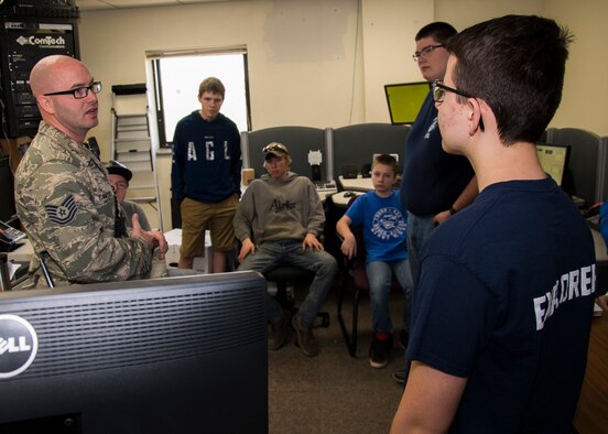 Tech. Sgt. Sean Cantrell, 5th Civil Engineering Squadron assistant chief of operations, explains the dispatch room’s purpose in the Kenneth O. Gillespie Fire Station at Minot Air Force Base, N.D., April 30, 2017. Boy Scouts of America and Fire Explorer Post #9463 from Minot toured the fire station and participated in a simulated fire rescue mission. (U.S. Air Force photo/Airman 1st Class Alyssa M. Akers)