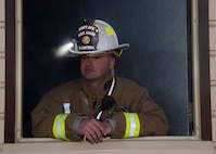 Tech. Sgt. Sean Cantrell, 5th Civil Engineering Squadron assistant chief of operations, prepares a burn room insulation system at Minot Air Force Base, N.D., April 30, 2017. Boy Scouts of America and Fire Explorer Post #9463 from Minot engaged in a simulated fire rescue mission, created with a fog machine and blinking red lights. (U.S. Air Force photo/Airman 1st Class Alyssa M. Akers)