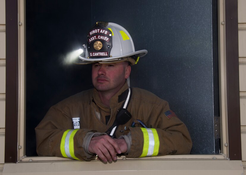 Tech. Sgt. Sean Cantrell, 5th Civil Engineering Squadron assistant chief of operations, prepares a burn room insulation system at Minot Air Force Base, N.D., April 30, 2017. Boy Scouts of America and Fire Explorer Post #9463 from Minot engaged in a simulated fire rescue mission, created with a fog machine and blinking red lights. (U.S. Air Force photo/Airman 1st Class Alyssa M. Akers)