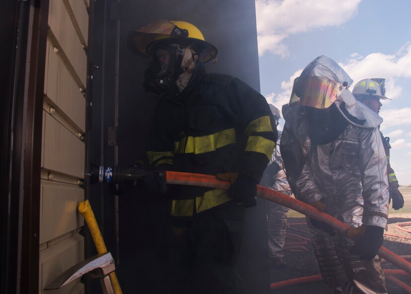 Boy Scouts of America and Fire Explorers from Post #9463 in Minot, N.D, enter the burn room insulation system at Minot Air Force Base, April 30, 2017. The group engaged in a simulated fire rescue mission, created with a fog machine and blinking red lights. (U.S. Air Force photo/Airman 1st Class Alyssa M. Akers)