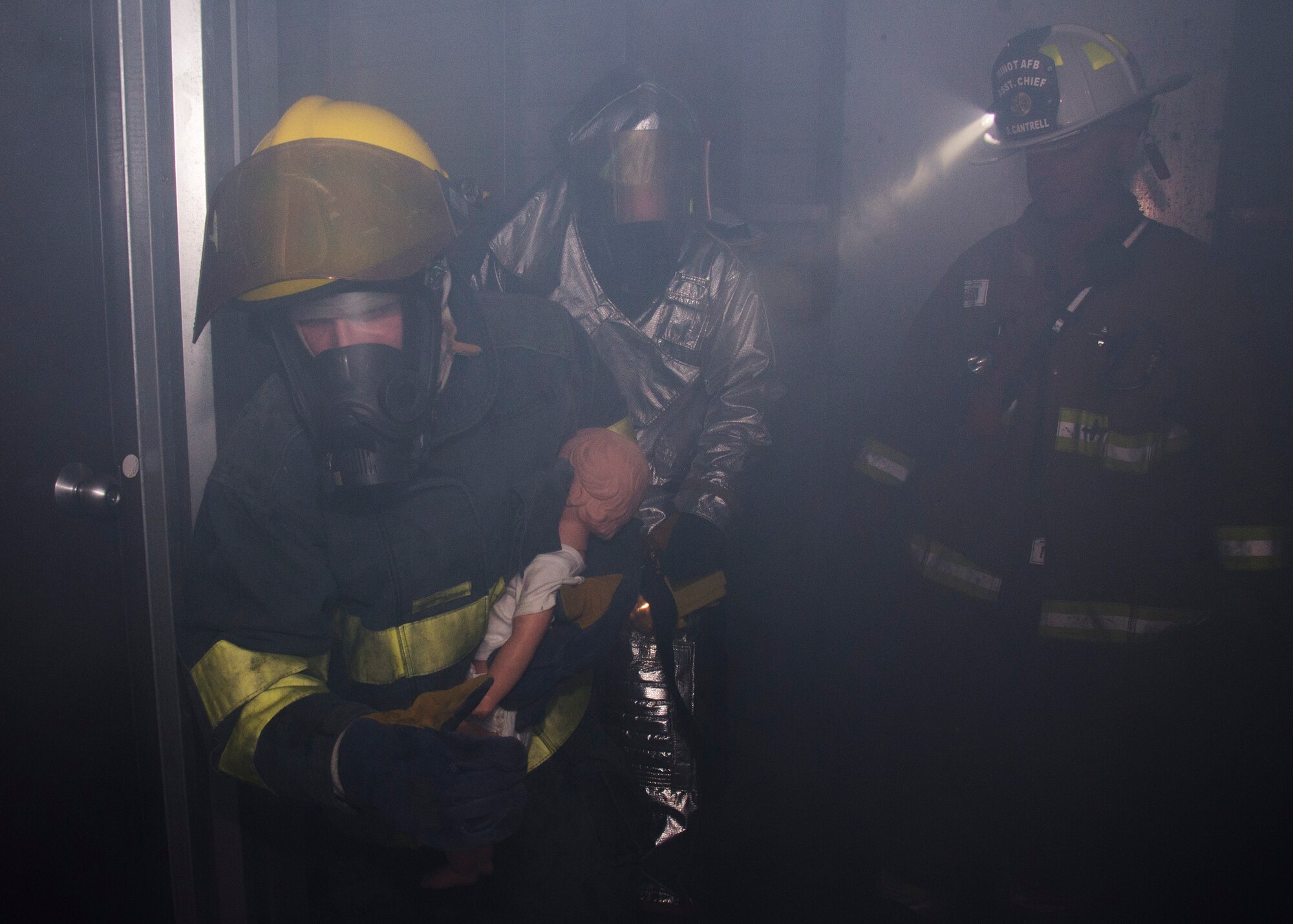 Alex Debowey, a Fire Explorer from Post #9463 in Minot, N.D., rushes a victim to safety during a simulated fire rescue mission at Minot Air Force Base, April 30, 2017. During the mission, the Minot Boy Scouts of America and Fire Explorers forced a door open, stopped a simulated fire, rescued victims and ventilated the area while following basic firefighting procedures. (U.S. Air Force photo/Airman 1st Class Alyssa M. Akers)