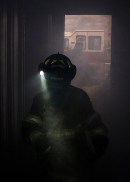 Ethan Beede, a Boy Scout of America from Minot, N.D., trudges through a fog machine’s smoke during a simulated fire rescue mission at Minot Air Force Base, April 30, 2017. Boy Scouts of America and Minot Fire Explorers Post #9463 learned about the fast-paced response required to fight fires. (U.S. Air Force photo/Airman 1st Class Alyssa M. Akers)