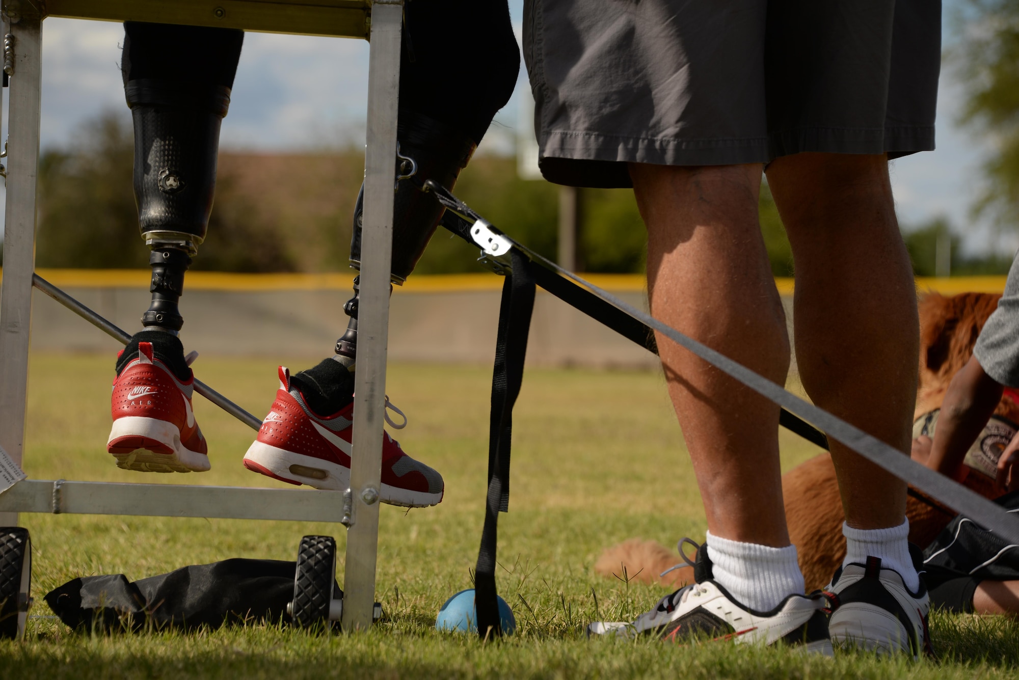 Christy Gardner, 2017 Paralympics competitor, receives coaching May 10, 2017, at Luke Air Force Base, Ariz. Over 60 volunteers from Luke AFB came together to support the track and field camp held on base as well as the 2017 Desert Challenge Games at Arizona State University on May 12 and 13. (U.S. Air Force photo by Airman 1st Class Caleb Worpel)