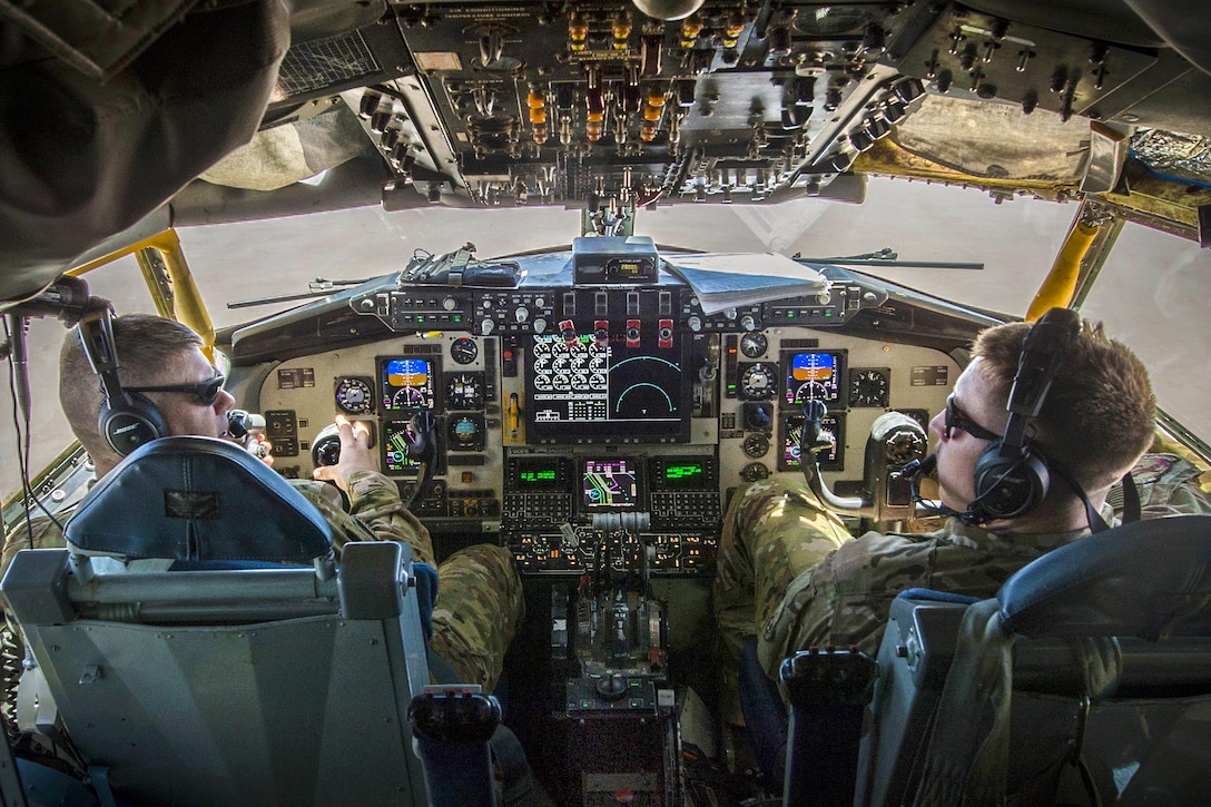 Two Air Force KC-135 Stratotanker pilots perform checks during a flight in an undisclosed location to support Operation Inherent Resolve, May 9, 2017. The pilots are assigned to the 340th Expeditionary Air Refueling Squadron. Air Force photo by Staff Sgt. Michael Battles