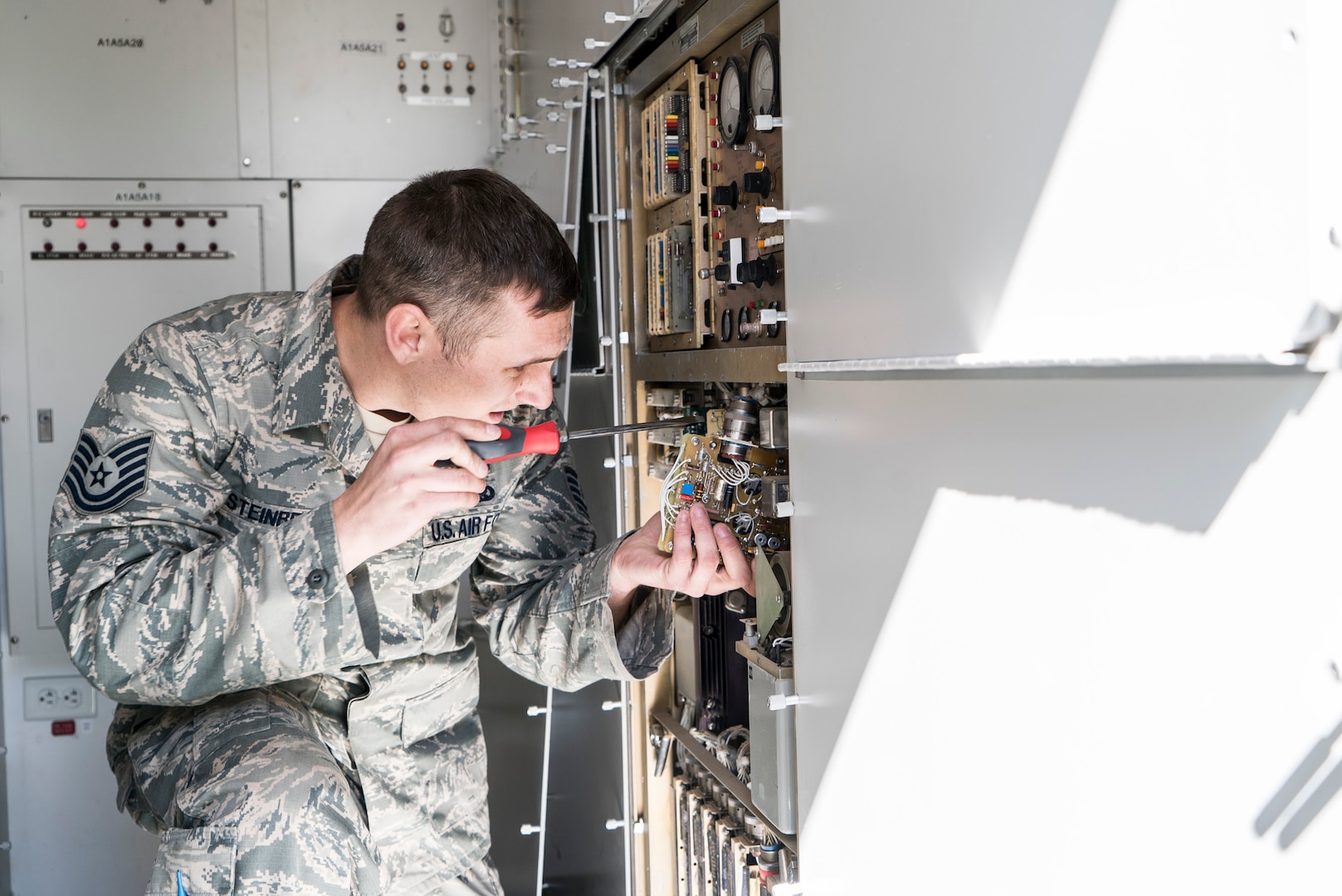 Tech. Sgt. Aaron Steinberg, 266th Range Squadron ground radar technician, installs a power supply on the Multiple Threat Emitter System at the Mountain Home Air Force Base Range Complex in Idaho May 9, 2017. The $20,000 power supply was broken and headed for the garbage, but the Air Force Repair Enhancement Program team managed to fix the part by replacing a $5 resistor. (U.S. Air Force photo/Staff Sgt. Samuel Morse)