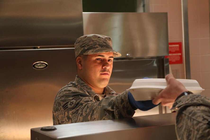 Senior Airman Anthony Nieves, 927th Force Support Squadron services technician delivers a to-go box during annual tour at RAF Mildenhall, England on May 9, 2017. Nieves was one of approximately 30 citizen airmen who served at Mildenhall during annual tour. (U.S. Air Force Photo by Staff Sgt. Xavier Lockley) 

