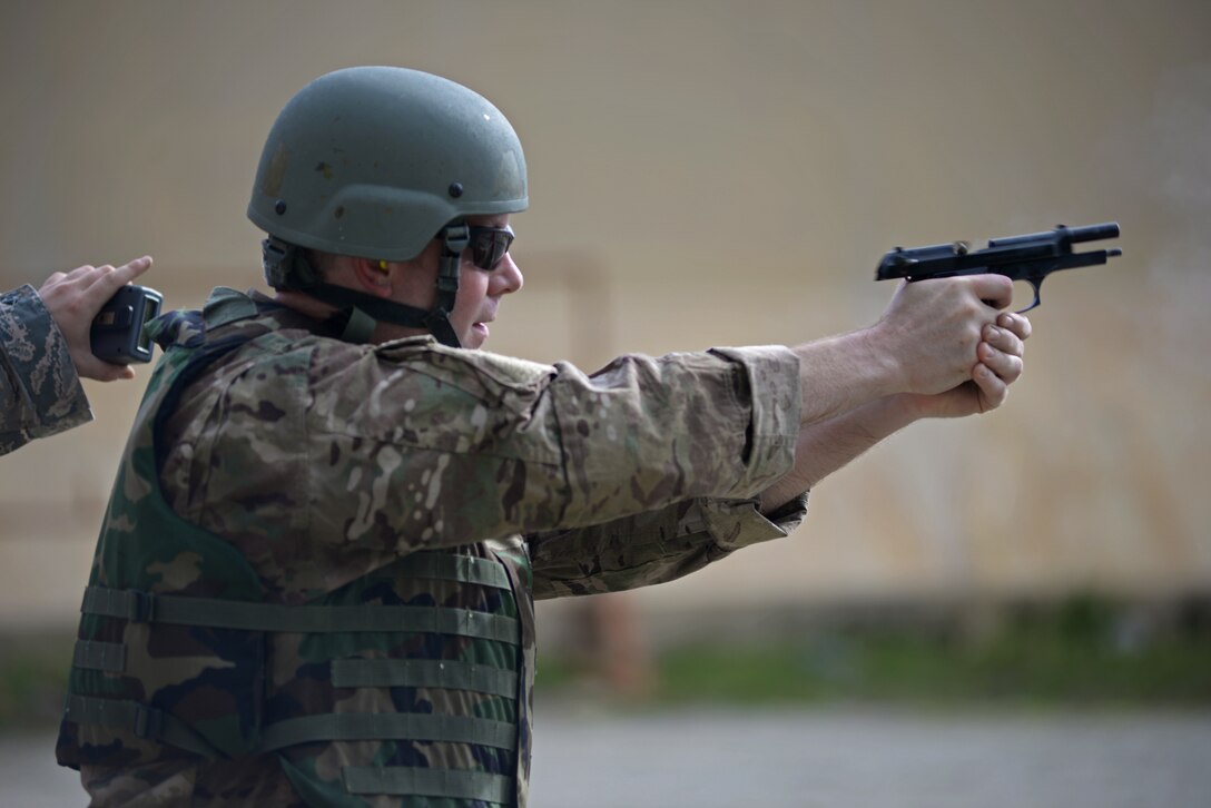 Master Sgt. Sean Elliot, 36th Operations Support Squadron airfield flight equipment superintendent, shoots an M9 pistol during the Defender Challenge May 15, 2017, at Andersen Air Force Base, Guam. The 36th Security Forces Squadron hosted the Defender Challenge, pitting Airmen against a variety of obstacles and navigational tasks. The event was part of National Police week, which honors the service and sacrifice of law enforcement officers. (U.S. Air Force photo by Senior Airman Joshua Smoot)