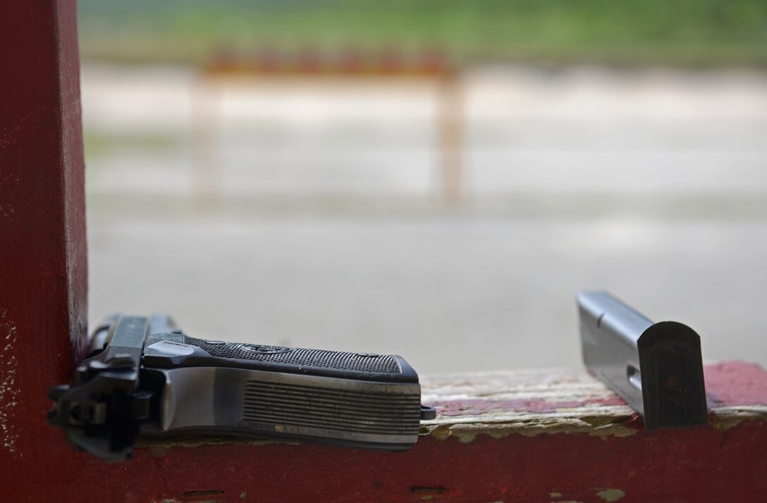 An M-9 pistol rests in the safe position after being used during the Defender Challenge May 15, 2017, at Andersen Air Force Base, Guam.  The 36th Security Forces Squadron hosted the Defender Challenge, pitting Airmen against a variety of obstacles and navigational tasks. The event was part of National Police week, which honors the service and sacrifice of law enforcement officers.  (U.S. Air Force photo by Senior Airman Joshua Smoot)