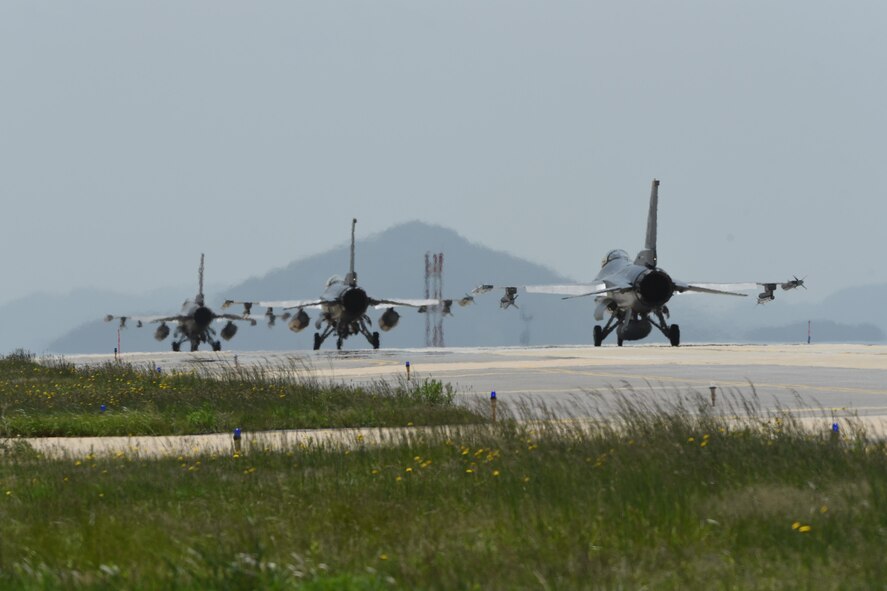 Three F-16 Fighting Falcons taxi down the flightline at Kunsan Air Base, Republic of Korea, May 15, 2017. Pilots from the 35th Fighter Squadron departed Kunsan to participate in Buddy Wing 17-4 at Jungwon Air Base, ROK. (U.S. Air Force photo by Senior Airman Michael Hunsaker/Released)