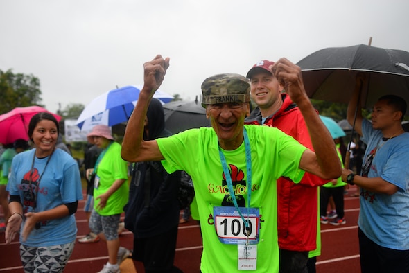 Special Olympic Guam contestants and volunteers parade around the track March 18, 2017, at Okkodo High School in Dededo, Guam. The event is one of many volunteer opportunities that Team Andersen members have participated in. (U.S. Air Force photo by Airman 1st Class Christopher Quail) 