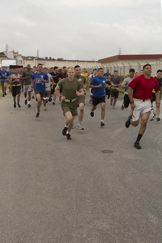 Marines and sailors take off during the Cpl. Medina and Lance Cpl. Hug 2nd Annual Memorial Run May 12 aboard Camp Foster, Okinawa, Japan. Participants were seen running, walking and even pushing baby strollers during the event. Marines, sailors and members of the military community came from all over Okinawa to honor Medina and Hug.