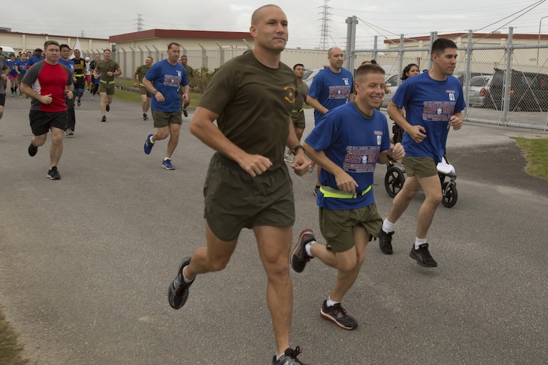 Col. William L. Depue Jr., second from the right, and Maj. Peter A. Baker, center, run alongside sailors and Marines during the Cpl. Sara Medina and Lance Cpl. Jacob Hug 2nd Annual Memorial Run May 12 aboard Camp Foster, Okinawa, Japan. On May 12, 2015, Cpl. Sara A. Medina, 23, a combat photographer and Lance Cpl. Jacob A. Hug, 22, a combat videographer assigned to Headquarters and Support Battalion, Marine Corps Installations Pacific-Marine Corps Base Camp Butler, Japan, died while providing humanitarian assistance and disaster relief to remote villages in Nepal during operation Sahayogi Haat. Marines, sailors and members of the military community came from all over Okinawa to honor Medina and Hug. Baker is the company commander for Bravo Company, Headquarters and Support Battalion MCIPAC-MCB Camp Butler, Japan. Depue is the Headquarters and Support Battalion commanding officer, and Camp Foster camp commander.