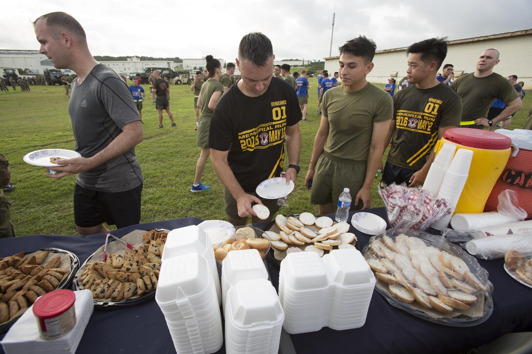 Marines grab food after the Cpl. Medina and Lance Cpl. Hug 2nd Annual Memorial Run May 12 aboard Camp Foster, Okinawa, Japan. On May 12, 2015, Cpl. Sara A. Medina, 23, a combat photographer and Lance Cpl. Jacob A. Hug, 22, a combat videographer assigned to Headquarters and Support Battalion, Marine Corps Installations Pacific-Marine Corps Base Camp Butler, Japan, died while providing humanitarian assistance and disaster relief to remote villages in Nepal during operation Sahayogi Haat. Marines, sailors and members of the military community came from all over Okinawa to honor Medina and Hug.