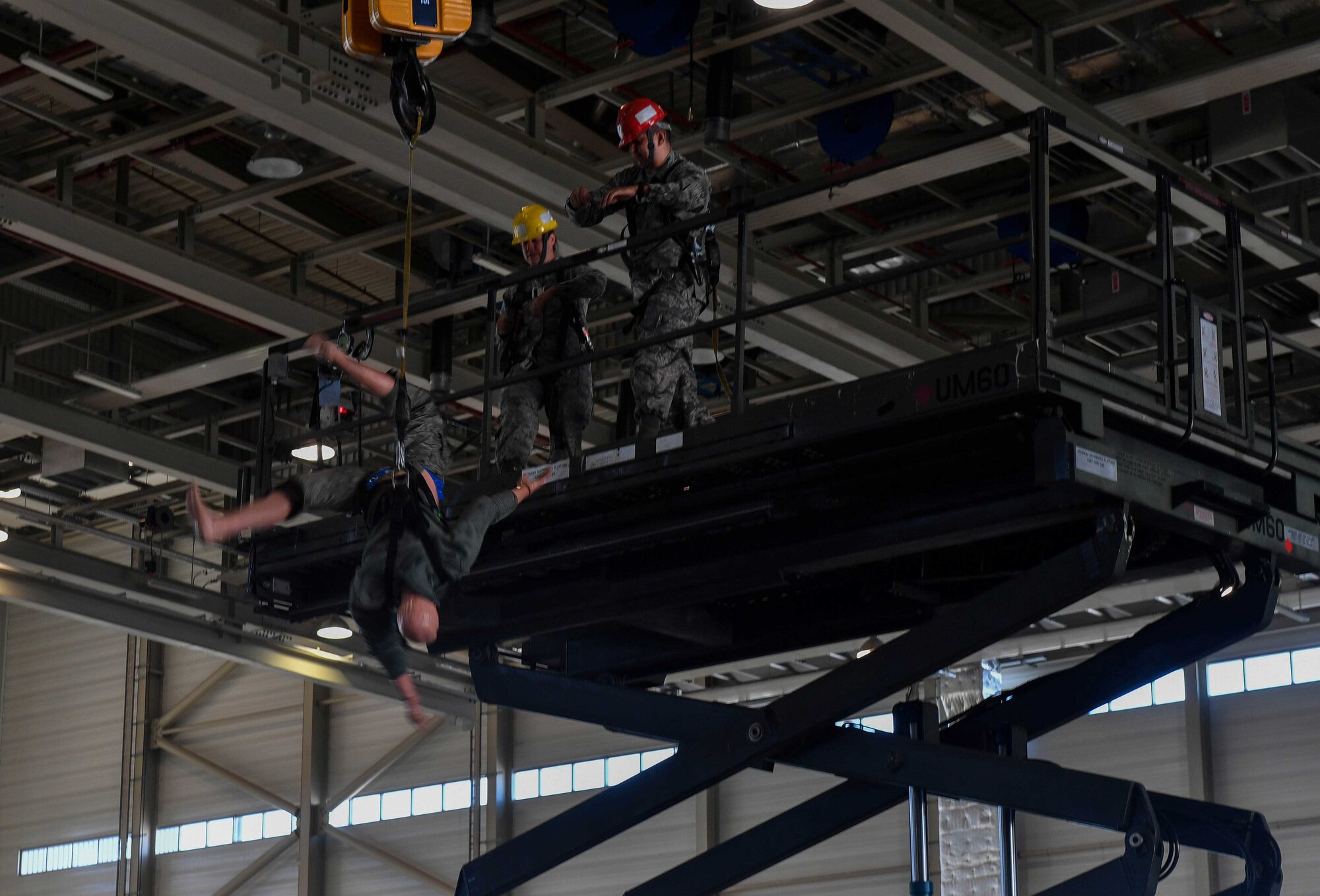 A 200-pound dummy drops from a platform to demonstrate a safety mechanism during the 721st Aircraft Maintenance Squadron's fall protection training on Ramstein Air Base, Germany, May 10, 2017. The Occupational Safety and Health Administration encouraged employers to participate in its National Fall Prevention Stand-Down, which was being held in conjunction with the North American Occupational Safety and Health Safety Week from May 8 to 12. (U.S. Air Force photo by Senior Airman Tryphena Mayhugh)