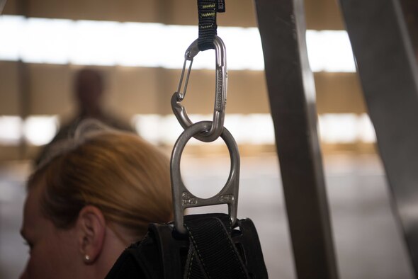 Capt. Teresa Crampton, 721st Aerial Port Squadron Passenger Services Flight commander, hangs in a safety harness on Ramstein Air Base, Germany, May 10, 2017. The 721st APS intended to train 70 personnel on fall protection as part of the Occupational Safety and Health Administration's Fall Prevention Stand-Down Week, which took place across the Air Force to prevent injuries and fatalities. (U.S. Air Force photo by Airman 1st Class Elizabeth Baker)