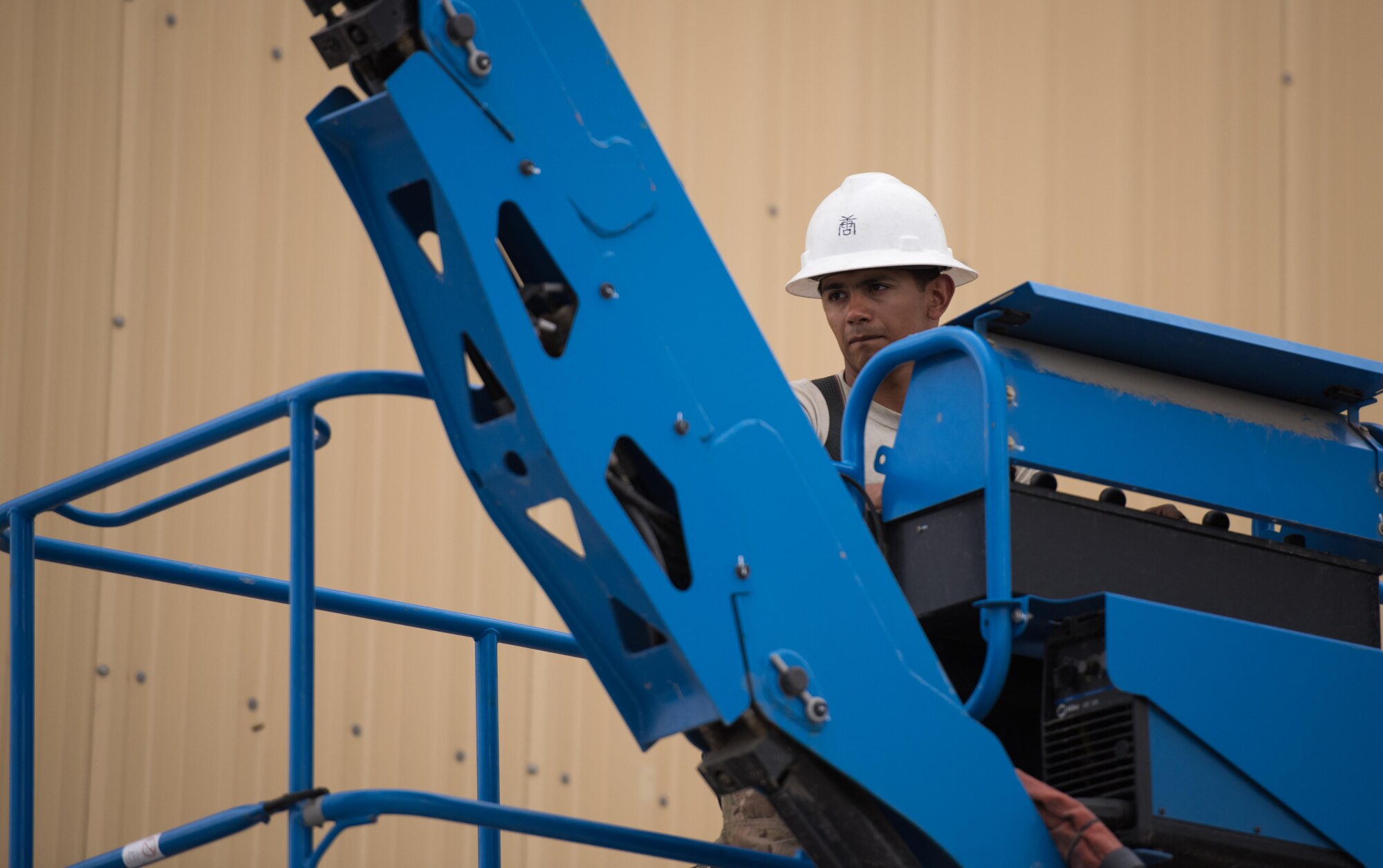 Senior Airman Peter Palacios, a 455th Expeditionary Civil Engineer Squadron electrical systems journeyman, operates a boom lift at Bagram Airfield, Afghanistan, May 12, 2017. Electricians are responsible for installing, repairing and maintaining electrical networks, ensuring that the primary source of energy for the installation is always available. (U.S. Air Force photo by Staff Sgt. Benjamin Gonsier)