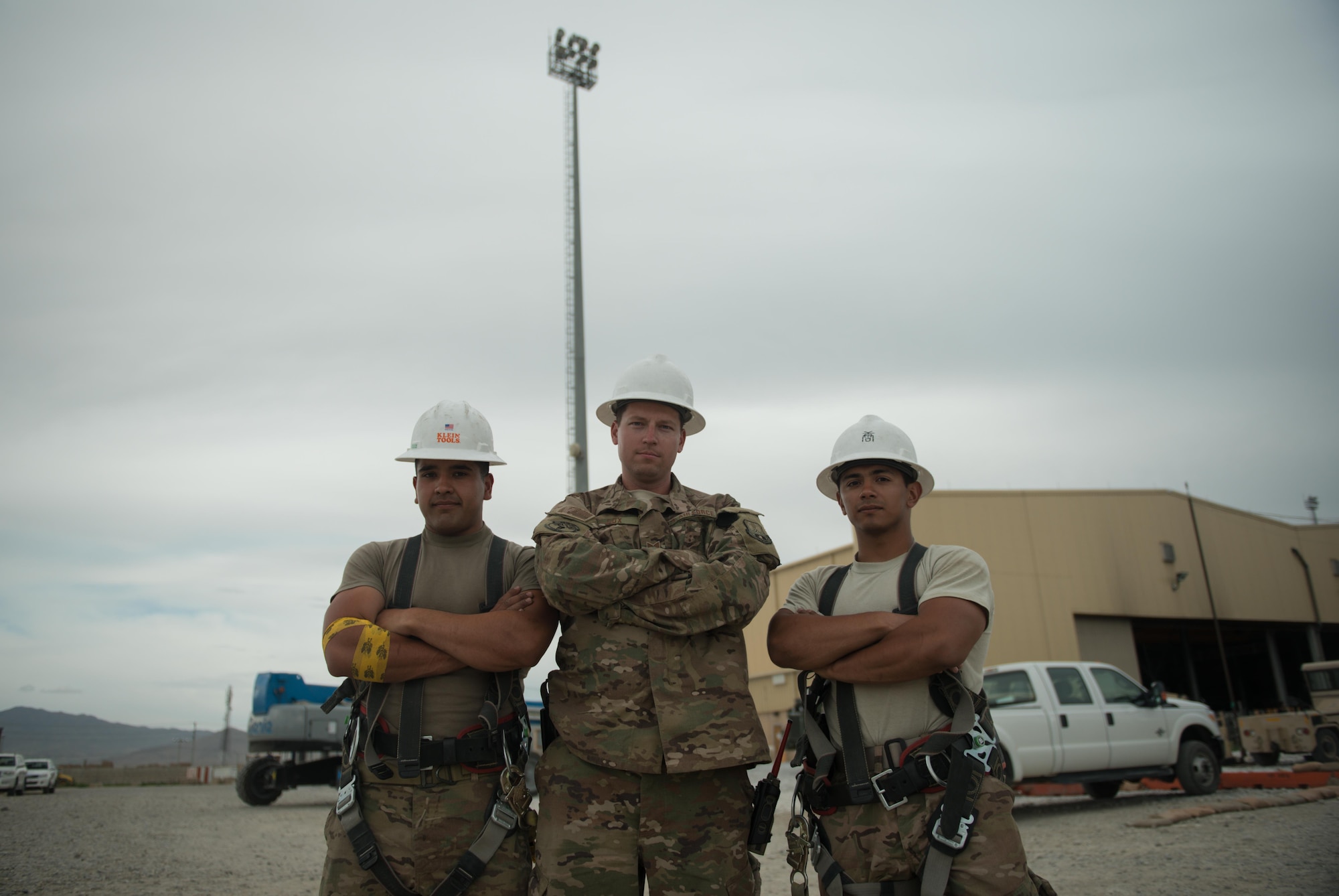Airmen from the 455th Expeditionary Civil Engineer Squadron pose for a photo at Bagram Airfield, Afghanistan, May 12, 2017. Civil Engineers work on systems that require them to go up to great heights, requiring multiple safety measures to minimize the risk of injury. Other than personal protective equipment like gloves and hard hats, engineers must wear a harness in case they fall. While falls are the leading cause of injuries in the U.S. Air Force, proper education, risk management and proactive supervision have been major in lowering these types of injuries. (U.S. Air Force photo by Staff Sgt. Benjamin Gonsier)