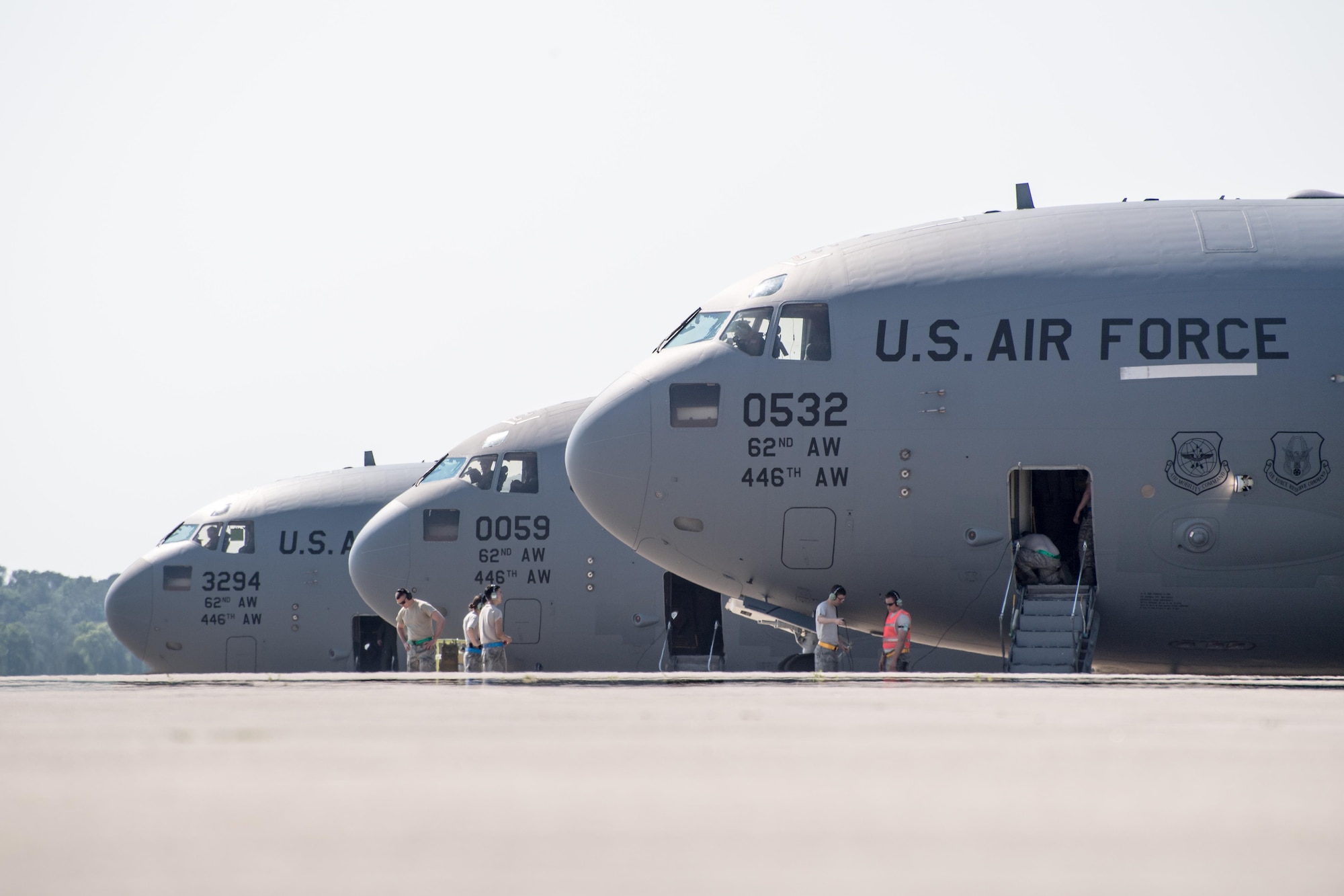 Airmen from Pope Field and Joint Base Lewis-McChord prepare to launch three C-17 Globemaster IIIs from Green Ramp here during a Large Package Week joint airdrop exercise April 27. Airmen here supported visiting aircrews from the 62nd Airlift Wing at McChord, as well as C-130 Hercules crews from Dyess Air Force Base, Texas and Little Rock Air Force Base, Arkansas during back-to-back exercises here April 27-May 5. (U.S. Air Force photo/Marc Barnes)