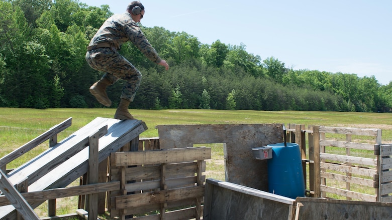 Staff Sgt. Christopher Sherrill, a competition shooter, jumps over an obstacle during the Marine Corps Championships at Marine Corps Base Quantico, Virginia, May 10, 2017. Each year, the Marine Corps Shooting Team hosts the championship matches for medalists from each Marine Corps Markmanship Competition site to compete in individual and team matches.
