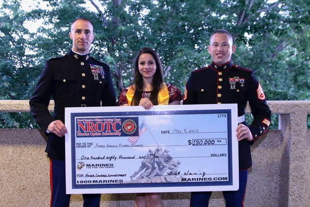 Veronica Andrea Romero-Dugarte receives a Naval Reserve Officers Training Corps scholarship check from U.S. Marine Corps Captain Brett Warming, left, and U.S. Marine Corps Staff Sgt. Brain Erdman at the Dewitt E. Rhoades Conference Center at Forsyth Tech Community College at Winston-Salem, North Carolina, May 8, 2017.  The NROTC scholarship, valued at up to $180,000, will pay for the cost of full tuition, books and other educational fees at many of the country’s leading colleges and universities. Veronica is currently a senior at Early College of North Forsyth.  (U.S. Marine Corps photo by Sgt. Antonio J. Rubio/Released)