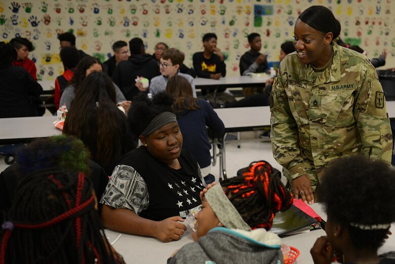 U.S. Army Sgt. 1st Class Shalayne Tucker, 2nd Staff and Faculty Company cargo handling division team chief and instructor writer, talks to students during a Lunch Buddies mentor session at Mary L. Passage Middle School in Newport News, Va., May 10, 2017. The partnership between the company and the middle school aims to foster good relations with the local community, as well as increase public awareness of the Army’s mission. (U.S. Air Force photo/Staff Sgt. Teresa J. Cleveland)