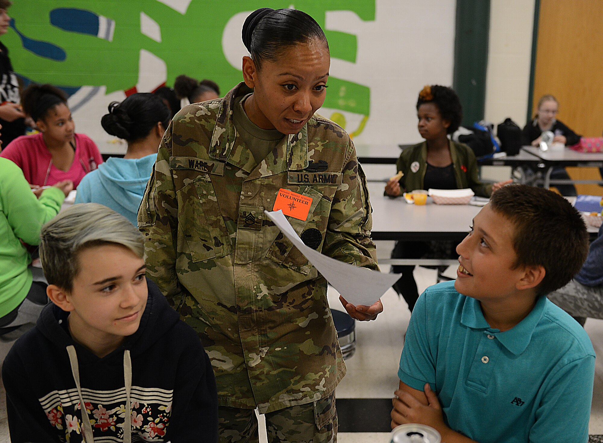 U.S. Army Staff Sgt. Yolanda Ware, 2nd Staff and Faculty Company cargo handling division instructor writer, talks to students about their grades during a Lunch Buddies mentor session at Mary L. Passage Middle School in Newport News, Va., May 10, 2017. During these lunch sessions with the students, the Soldiers provide mentorship and guidance, as well as someone who talk to about day-to-day stressor, their home life and school. (U.S. Air Force photo/Staff Sgt. Teresa J. Cleveland)