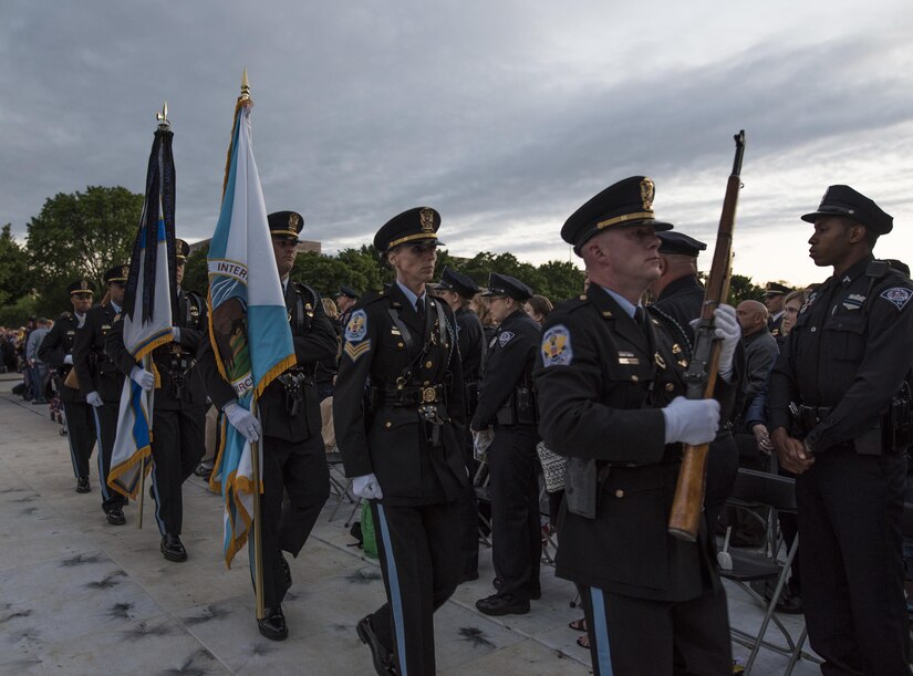The United States Park Police Honor Guard exits the stage during the opening ceremony of the 29th Annual Candlelight Vigil honoring fallen police officers from around the country on the National Mall in Washington, D.C., May 13, 2017. Approximately 300 police officers' names were read, engraved into the National Police Memorial. Among those names was Staff Sgt. James D. McNaughton, a U.S. Army Reserve military police who was the first New York City police officer killed in action while deployed to Iraq, Aug. 2, 2005. (U.S. Army Reserve photo by Sgt. Audrey Hayes)