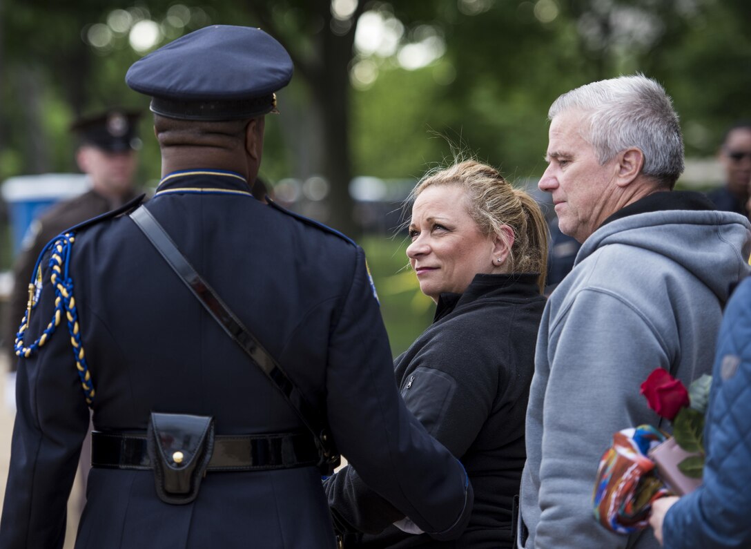 William and Michele McNaughton, from Centereach, New York, are escorted to their seat during the 29th Annual Candlelight Vigil to represent their son on the National Mall in Washington, D.C., May 13, 2017. McNaughton was a U.S. Army Reserve military police who was the first New York City police officer killed in action while deployed to Iraq, Aug. 2, 2005. Approximately 300 police officers' names were read, engraved into the National Police Memorial. (U.S. Army Reserve photo by Sgt. Audrey Hayes)