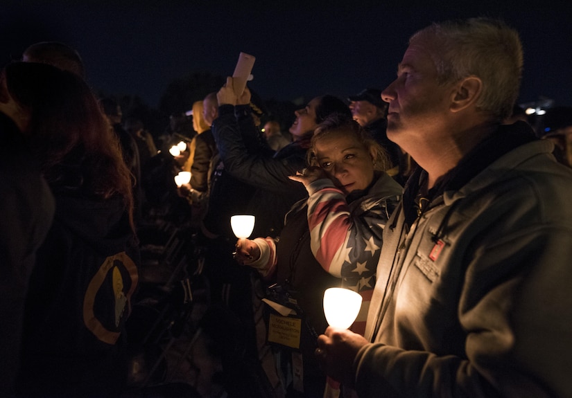 Michele McNaughton wipes tears from her face while remembering her son, Staff. Sgt. James D. McNaughton during the 29th Annual Candlelight Vigil, honoring fallen police officers from around the country on the National Mall in Washington, D.C., May 13, 2017. McNaughton was a U.S. Army Reserve military police who was the first New York City police officer killed in action while deployed to Iraq, Aug. 2, 2005. Approximately 300 police officers' names were read, engraved into the National Police Memorial. (U.S. Army Reserve photo by Sgt. Audrey Hayes)