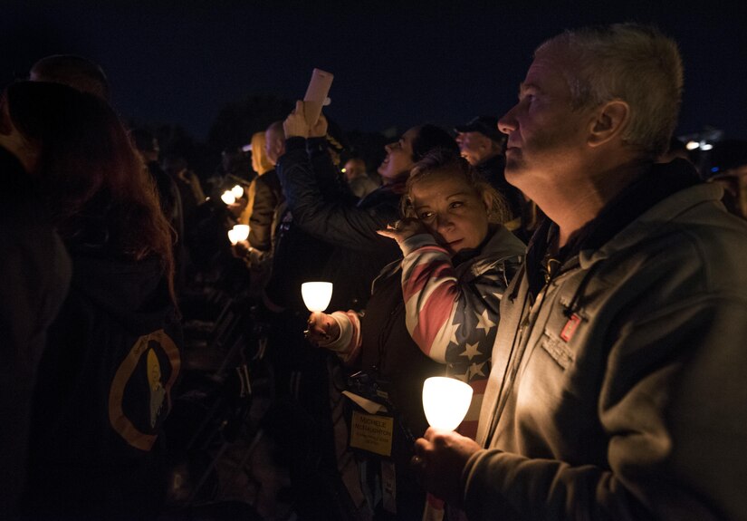 Michele McNaughton wipes tears from her face while remembering her son, Staff. Sgt. James D. McNaughton during the 29th Annual Candlelight Vigil, honoring fallen police officers from around the country on the National Mall in Washington, D.C., May 13, 2017. McNaughton was a U.S. Army Reserve military police who was the first New York City police officer killed in action while deployed to Iraq, Aug. 2, 2005. Approximately 300 police officers' names were read, engraved into the National Police Memorial. (U.S. Army Reserve photo by Sgt. Audrey Hayes)