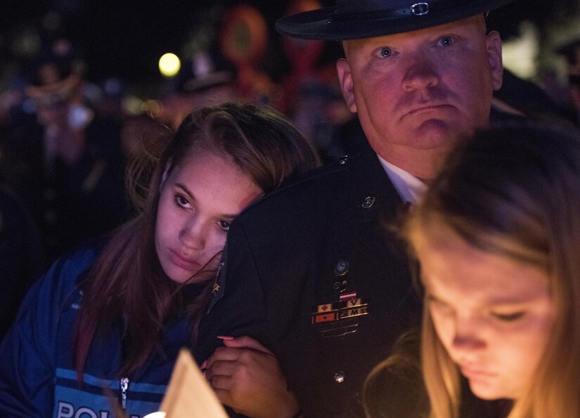 Police officers and family members attend the 29th Annual Candlelight Vigil honoring fallen police officers from around the country Saturday, on the National Mall in Washington, D.C., May 13, 2017. Approximately 300 police officers' names were read, engraved into the National Police Memorial. Among those names was Staff Sgt. James D. McNaughton, a U.S. Army Reserve military police who was the first New York City police officer killed in action while deployed to Iraq, Aug. 2, 2005.