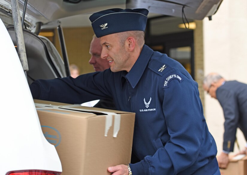 Col. E. John Teichert, 11th Wing and Joint Base Andrews commander, loads a box of food into a truck at Joint Base Andrews, Md., May 12, 2017. The JBA Defense Agency Commissary celebrated the donation of its 30,000th pound of food since June 2015 as part of Mission Nutrition to the Community Support Systems Baden Food Pantry. )