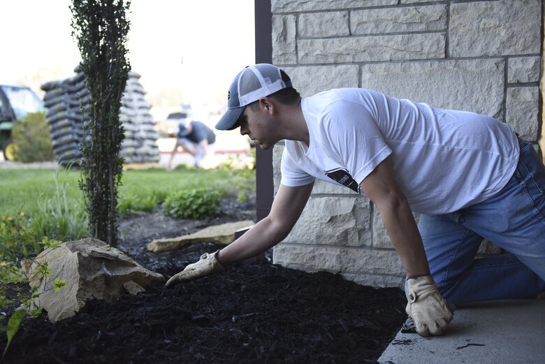 U.S. Air Force Master Sgt. Justin McCowan, the Operations Veterans Rising (OVR) president and a production control supervisor assigned to the 442d Maintenance Group, places new mulch to beautify the exterior of the Warrensburg Veterans Home, Mo., April 15, 2017. The Operation Veterans Rising is a non-profit organization created to help veterans and their families rise up from their daily struggles through a variety of financial aid programs. (U.S. Air Force photo/ Senior Airman Danielle Quilla) 