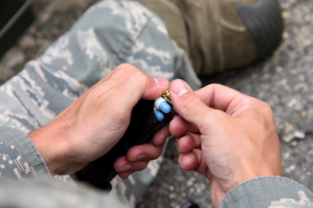 U.S. Air Force Staff Sgt. Orin Davidson, a police officer from the 459th Security Forces Squadron, loads marking [paintball-type] rounds into his M9 pistol magazine at Joint Base Andrews, Maryland, in preparation for “Shoot, Move, Communicate” Training on May 7, 2017. All SFS members must qualify with the M4 Rifle and M9 pistol annually in conjunction with quarterly SMC Training in order to maintain currency and keep their skills sharp.