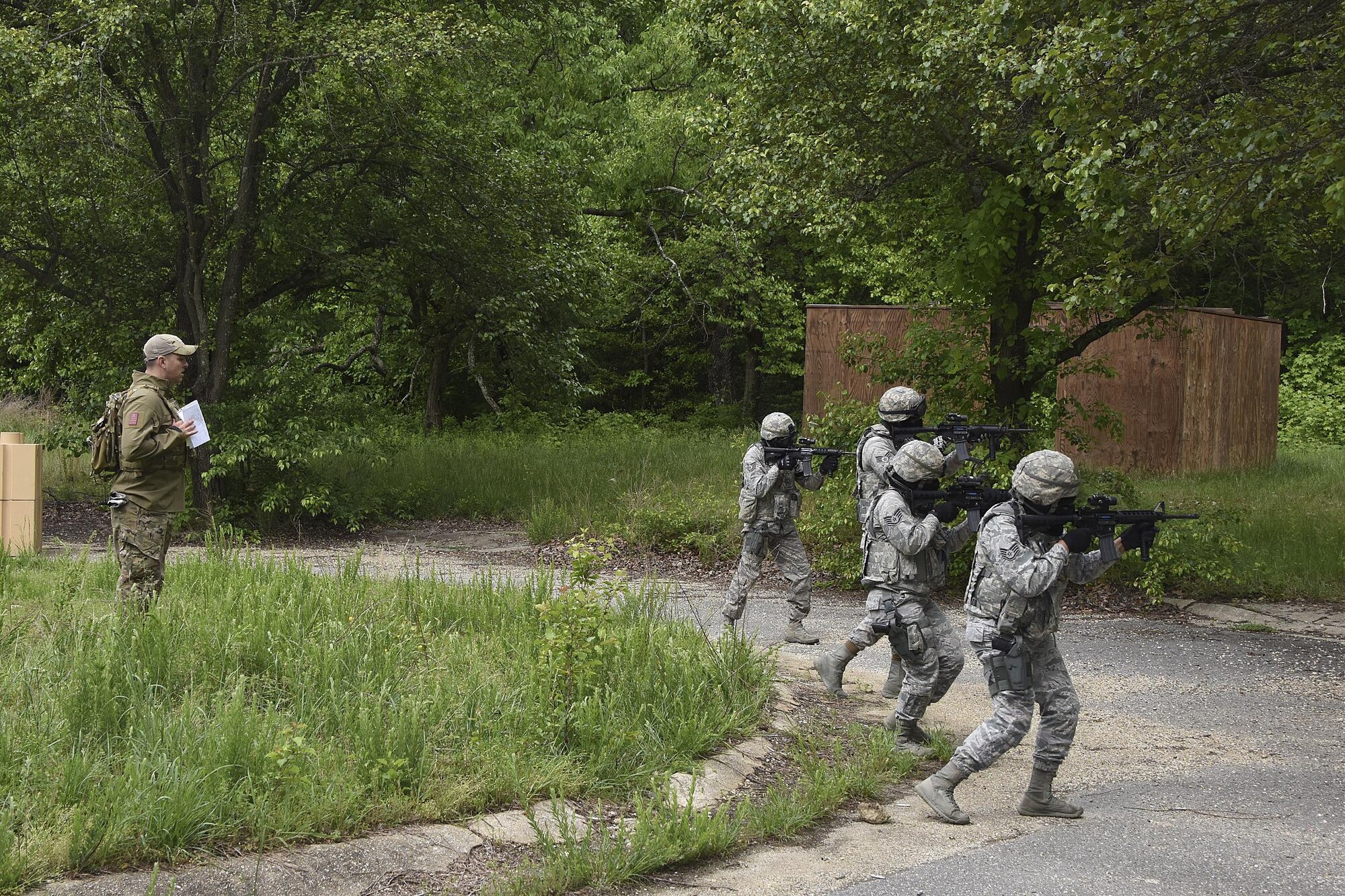 U.S. Air Force Tech. Sgt. Michael Perez, a  459th Security Forces Squadron instructor, observes as 459th SFS members engage a target during “Shoot, Move, Communicate” Training on May 7, 2017. All SFS members must qualify with the M4 Rifle and M9 pistol annually in conjunction with quarterly SMC Training in order to maintain currency and keep their skills sharp.