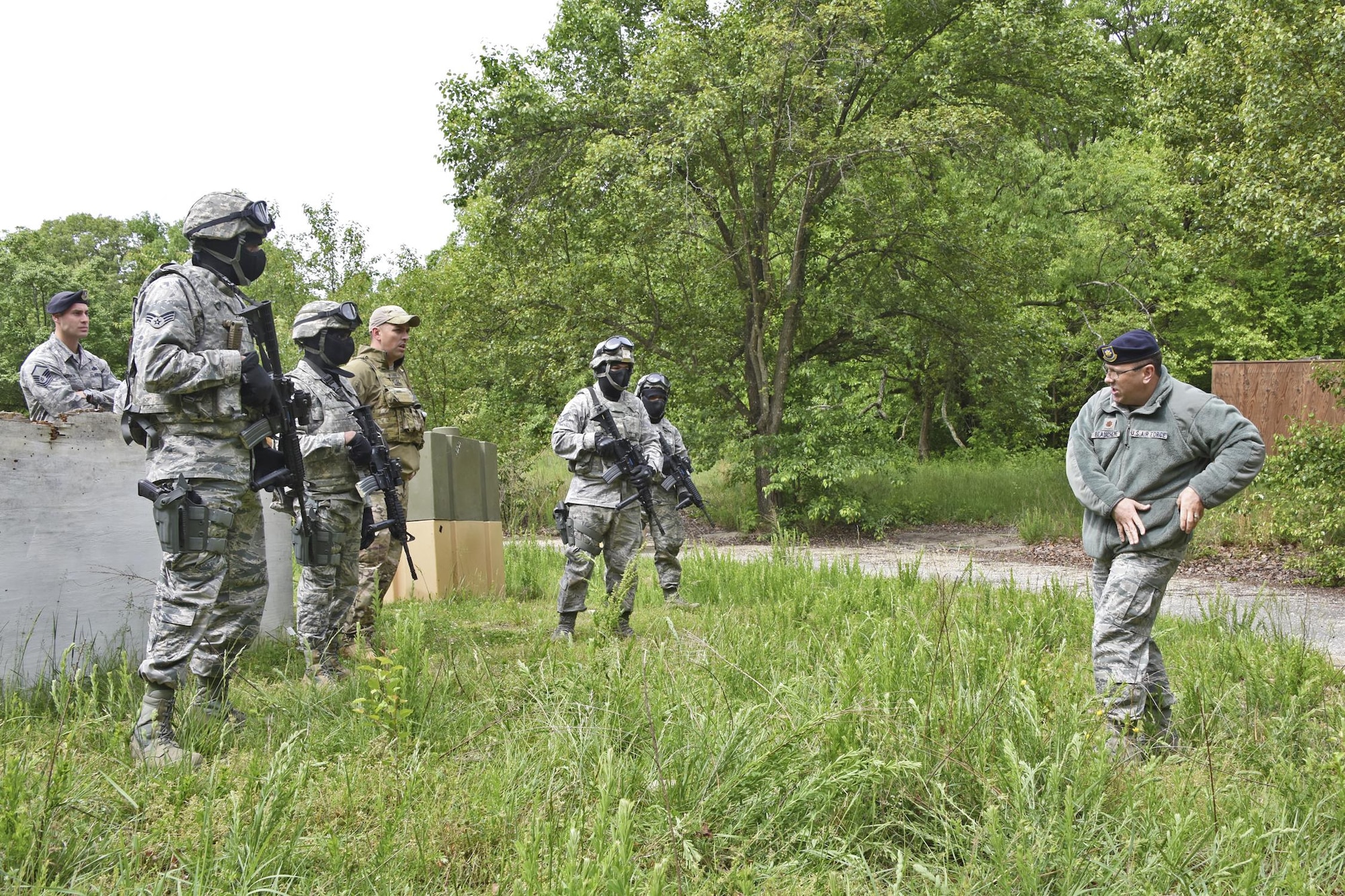U.S. Air Force Maj. William Beauchene, right,  459th Security Forces Squadron commander demonstrates to 459th SFS members how to quickly switch between weapons while engaging a target during “Shoot, Move, Communicate” Training on May 7, 2017. All SFS members must qualify with the M4 Rifle and M9 pistol annually in conjunction with quarterly SMC Training in order to maintain currency and keep their skills sharp.